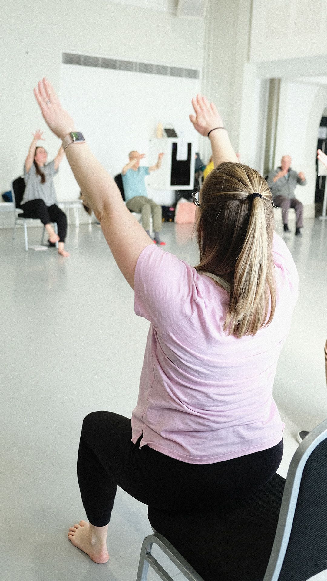 Aimee Hobbs (Parkinson's dance teacher) reaching both hands up