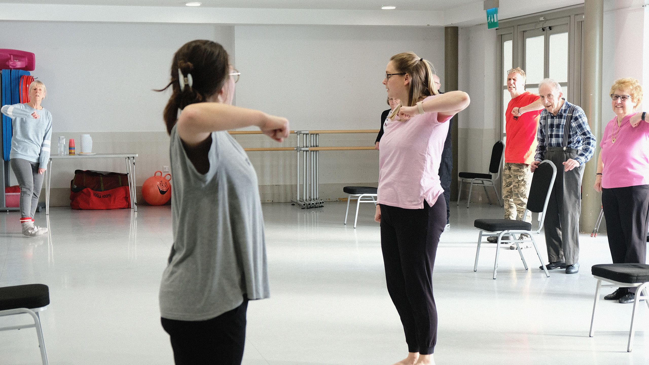 Two dance teachers lifting elbows out sideways