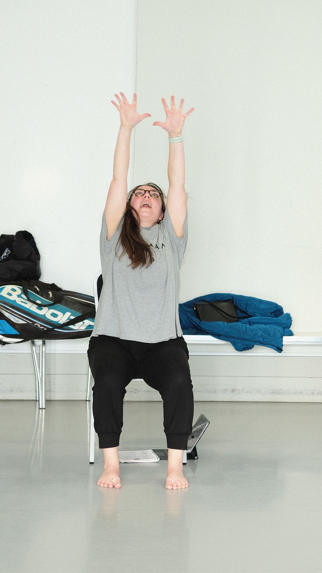 Samantha Gillingham (dance teacher) raising her hands high in the air